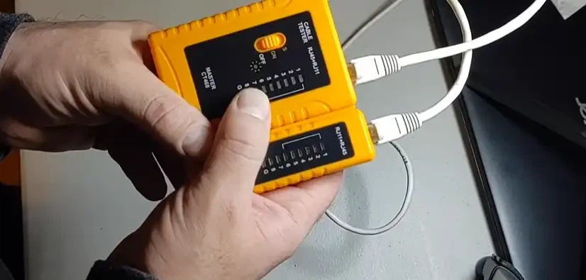 Technician testing an Ethernet cable with a cable tester Technician testing an Ethernet cable with a cable tester